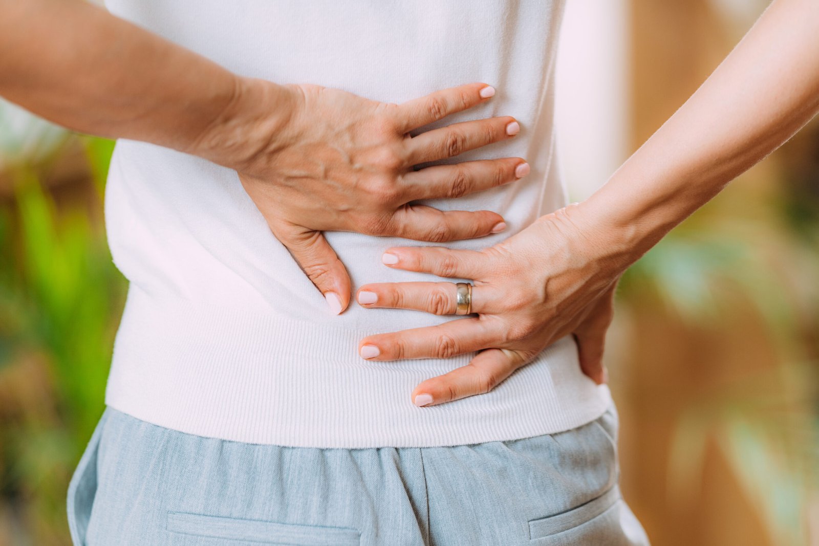 Sciatica nerve pain. Woman with pain in lower back.